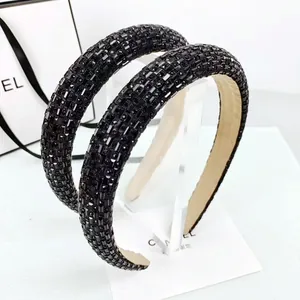 Detail of black wide headband with rhinestones and comfortable beige suede inner lining