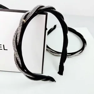 Detail of twisted black headband with densely inlaid shimmering rhinestones in luxury style