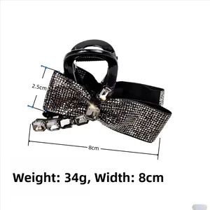 Detail of elegant black bow hair claw with sparkling rhinestones and size dimensions