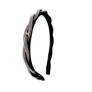 Detailed view of intertwined black twisted headband with rows of shiny crystal rhinestones