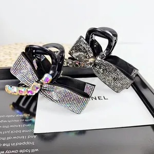 Elegant bow-shaped hair claw clips with sparkling rhinestones in black and silver finishes