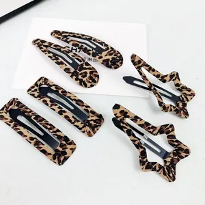 Set of 5 leopard print hair clips including star and droplet shapes on white background