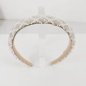 Detailed view of luxury pearl and rhinestone headband with soft fabric lining
