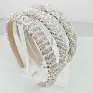 Macro shot of elegant cream faux pearls and iridescent rhinestones on narrow fashion headband