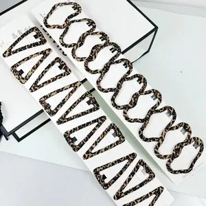Close-up of leopard print hair clips in wave and triangle shapes on a display card