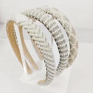 Detailed view of handmade pearl headbands with rhinestone accents and soft velvet lining