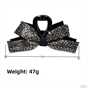 Detail view showing 13cm large black bow hair claw clip with shiny silver grey rhinestones