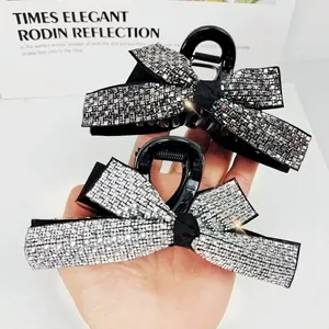 Sparkling crystal bow shark clip in silver and grey rhinestone for elegant hair styling