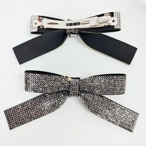 Sparkling crystal bow hair clips with metal spring mechanism shown from both sides