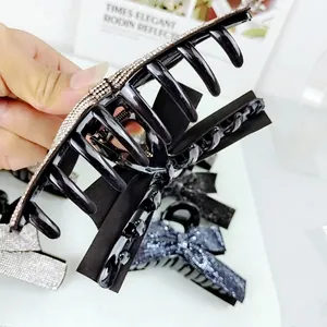 Grande pince à cheveux noire de luxe avec strass argentés et motif de nœud chic
