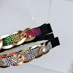 Macro view of gold chain headbands with colorful rhinestones and reflective shadows