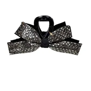 Sparkling rhinestone bow hair claw clip in black and silver for elegant women styling