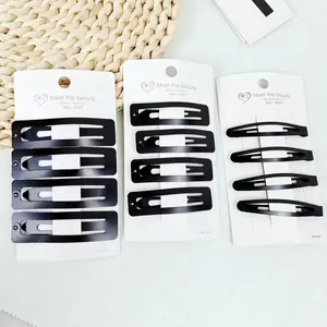 Set van matzwarte metalen haarspelden met rechthoekige en ovale ontwerpen op kaarten