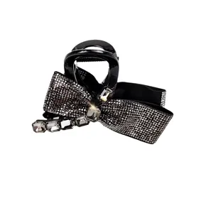 Elegant black bow hair claw clip with sparkling rhinestones and crystal embellishments