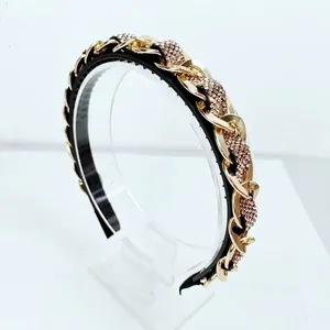 Detail of gold metal chain headband with inlaid purple rhinestones and non-slip teeth