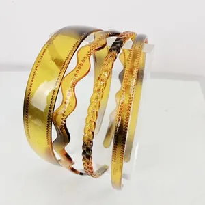 Set of four amber resin headbands featuring wave, woven, and smooth textured designs