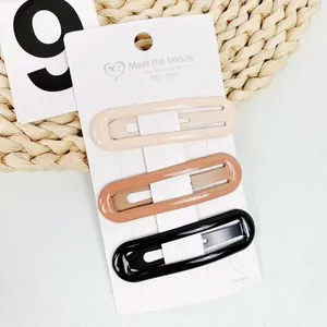 Three-piece set of oval hair clips in milk tea colors on white display card