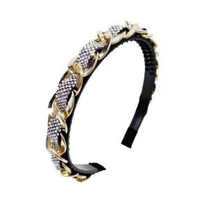 Elegant baroque headband with gold chain and colorful rhinestones on a black band