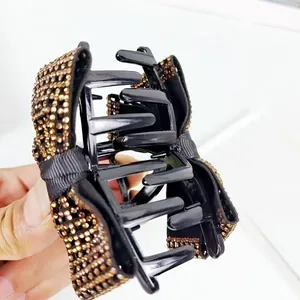 Elegante grote zwarte haarklem met strik en fonkelende amberkleurige steentjes dames