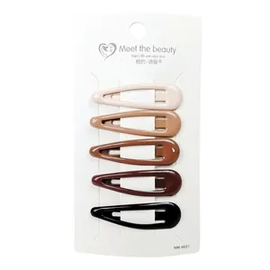 Detailed set of five earth-toned star BB hair clips on a professional display card
