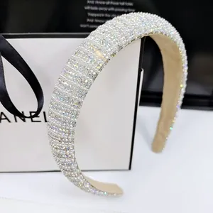 Detail of high-crown padded headband with AB crystals and pearls on beige suede lining