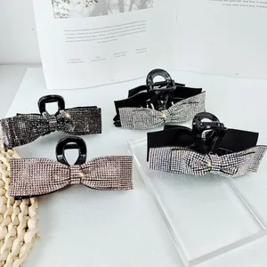 Elegant bow-shaped shark hair claws with shimmering rhinestones in four assorted colors
