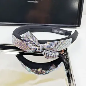 Macro detail of high-end sponge headband with a large sparkling rhinestone bow