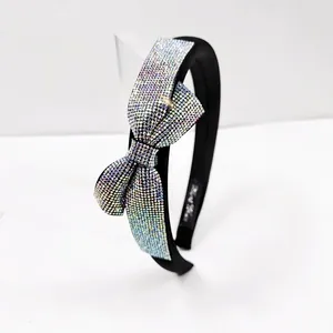 Detail of luxury sponge headband with large bow and colorful AB rhinestones