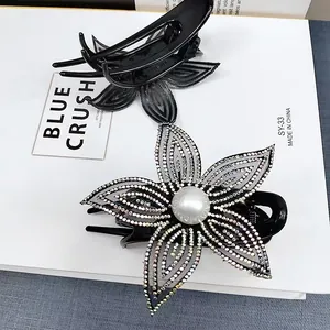 Elegante molletta per capelli a fiore con strass colorati e perla su base in resina nera