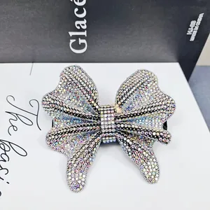 Macro detail of bow hair clip with colorful rhinestones on a metal base