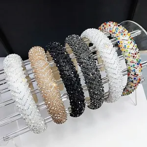 Detail of wide sparkling crystal headbands in six colors on clear acrylic display