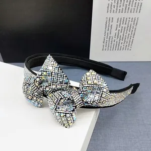 Macro shot of shimmering rhinestones on an elegant velvet bow headband accessory