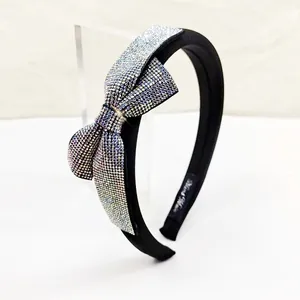 Close-up of a high-end black bow headband covered in colorful sparkling rhinestones