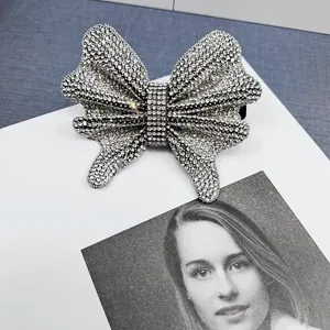 Macro view of full crystal bow hairpin showing detailed sparkling rhinestones craftsmanship