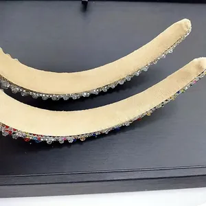 Detail of baroque crystal headbands featuring multi-colored rhinestones and beige suede base
