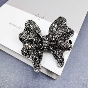 Detail of elegant black rhinestone bow hair clip with luxury shimmering crystal finish