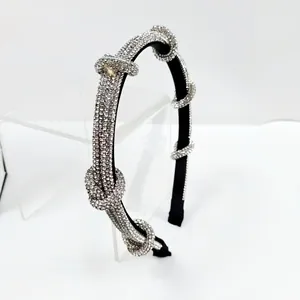 Close-up of black rhinestone headband featuring exquisite crystal knots and shiny details