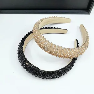 Close-up of black and champagne crystal beaded headbands with sponge padded design