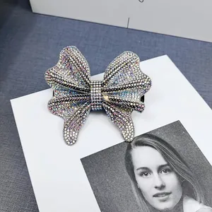 Detailed view of rhinestone butterfly hair clip with iridescent AB crystals and black clip