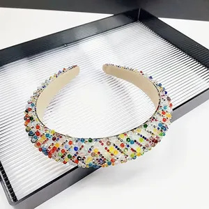 Close-up of colorful rhinestones and beads on a wide headband for a sparkling look