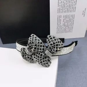 Close-up of a sparkling rhinestone bow headband with intricate crystal embroidery details