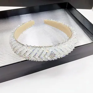 Detailed view of luxury crystal headband with shimmering diamonds and beige velvet lining