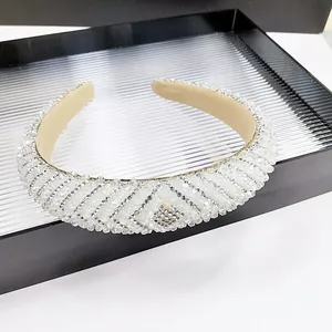 Sparkling crystal padded headband with intricate beadwork and rhinestones for elegant styling