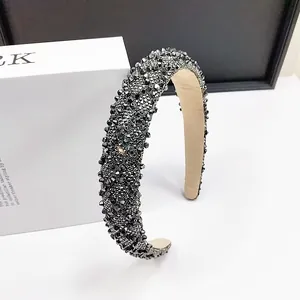 Detailed macro view of dense crystal beadwork on padded headband with shimmering finish