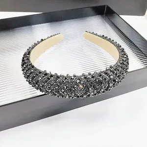 Close-up of sparkling black faceted crystal beads on a padded headband with fabric lining