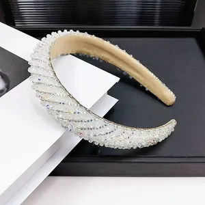 Detailed view of luxury padded headband with shimmering crystals and soft beige lining
