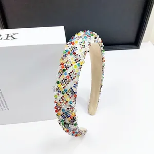 Close-up of sparkling colorful crystal beads on a padded sponge headband for women
