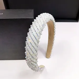 Detailed close-up showing the dense crystal inlay and soft fabric lining of the luxury headband