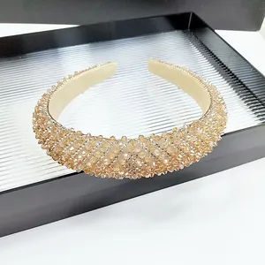 Macro detail of champagne crystal headband with thick sponge padding and glitter beads