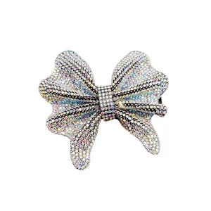 Elegant bow-shaped hair clip featuring colorful rhinestones on a polished metal base